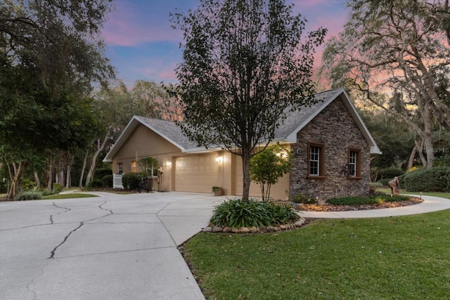 view of front of home featuring a garage and a lawn