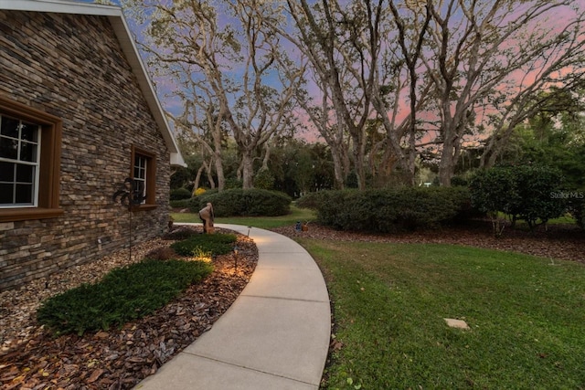 view of home's community with a lawn