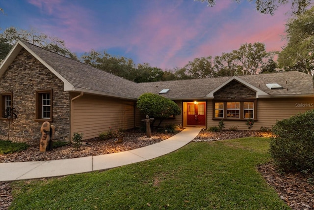 single story home featuring a yard