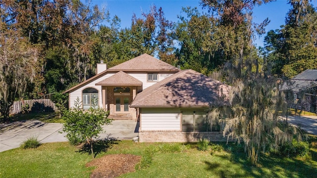 view of front facade with french doors and a front lawn