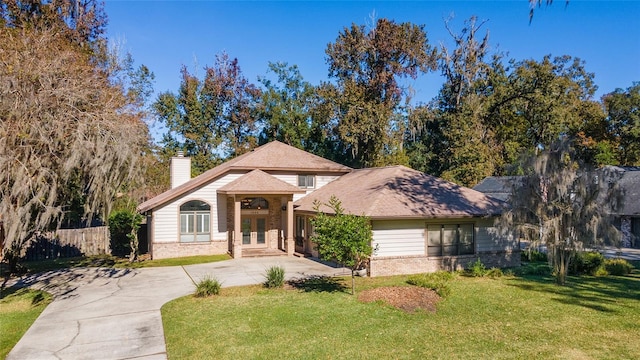 view of front of property featuring a front yard and french doors