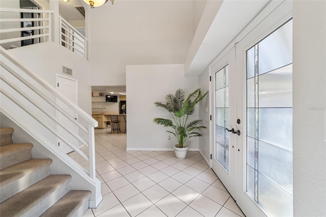 entrance foyer featuring french doors and light tile patterned floors