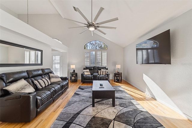 living room featuring light wood-type flooring, high vaulted ceiling, and ceiling fan