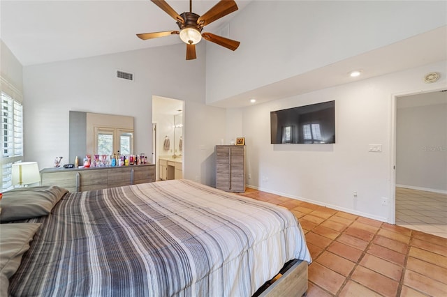 tiled bedroom featuring multiple windows, ceiling fan, ensuite bath, and high vaulted ceiling