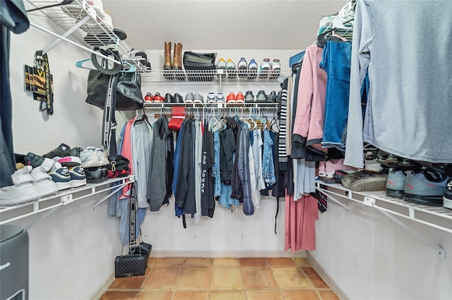 spacious closet featuring tile patterned flooring