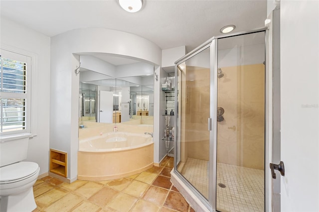 bathroom with tile patterned flooring, toilet, and shower with separate bathtub