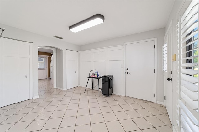 foyer entrance with plenty of natural light and light tile patterned flooring