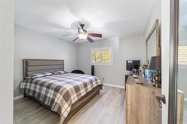 bedroom featuring light hardwood / wood-style floors and ceiling fan