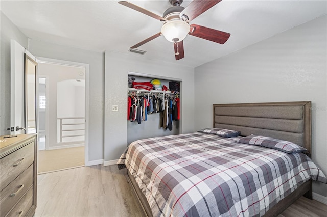 bedroom featuring ceiling fan, a closet, and light hardwood / wood-style flooring