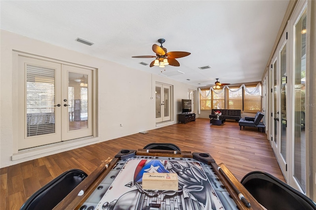 interior space with hardwood / wood-style floors, ceiling fan, and french doors