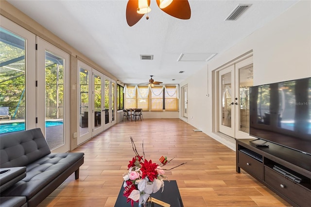 sunroom with ceiling fan and french doors