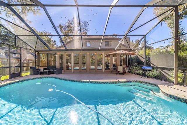 view of pool featuring glass enclosure and a patio