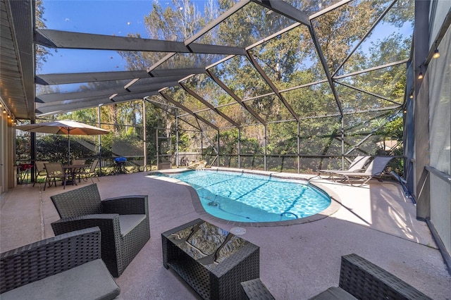 view of pool with a patio and a lanai