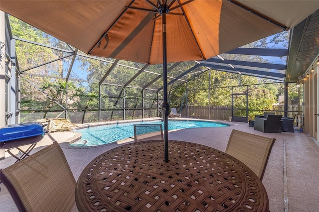 view of pool featuring glass enclosure, a grill, and a patio