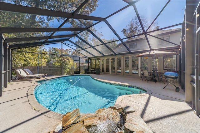 view of swimming pool with a lanai and a patio area