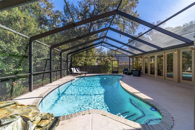 view of pool featuring a patio area and glass enclosure