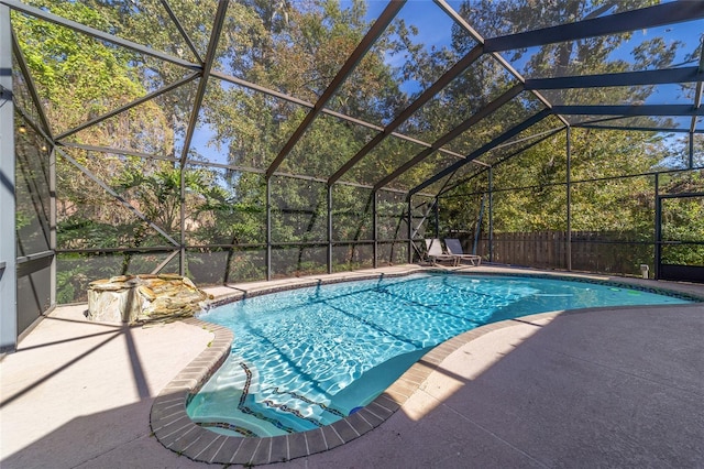 view of swimming pool with a patio and glass enclosure