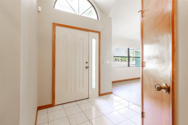 tiled entrance foyer featuring lofted ceiling