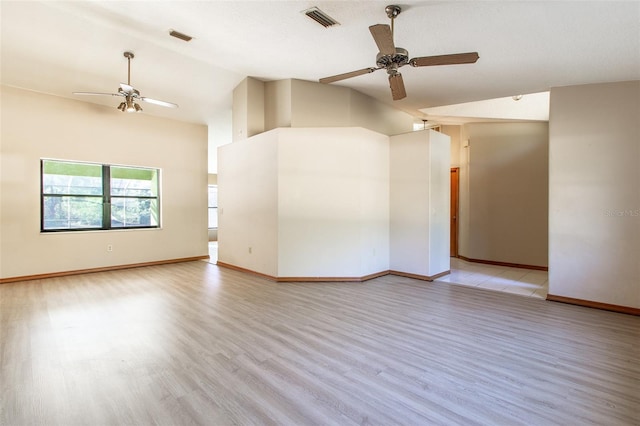 spare room with ceiling fan, light hardwood / wood-style floors, lofted ceiling, and a textured ceiling