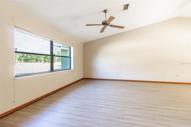 spare room with ceiling fan, light hardwood / wood-style flooring, and vaulted ceiling