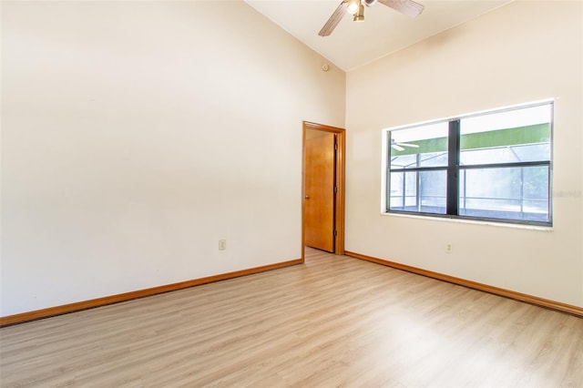 spare room with ceiling fan, high vaulted ceiling, and light hardwood / wood-style flooring