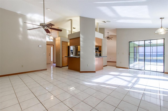 unfurnished living room with high vaulted ceiling, ceiling fan, and light tile patterned flooring