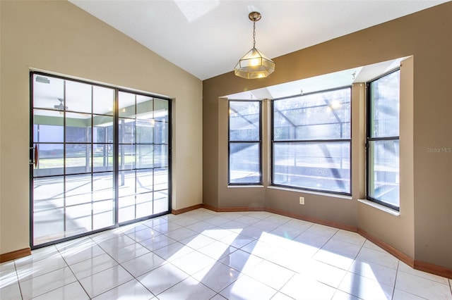 spare room with ceiling fan, light tile patterned flooring, lofted ceiling, and a wealth of natural light