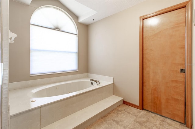 bathroom featuring a tub to relax in