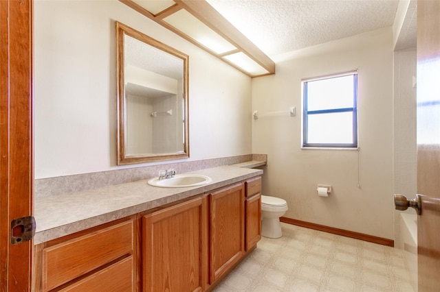 bathroom featuring a shower, vanity, a textured ceiling, and toilet