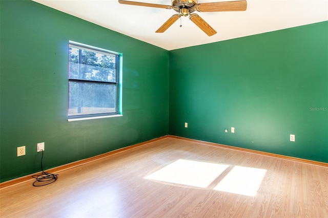 spare room featuring light hardwood / wood-style floors and ceiling fan