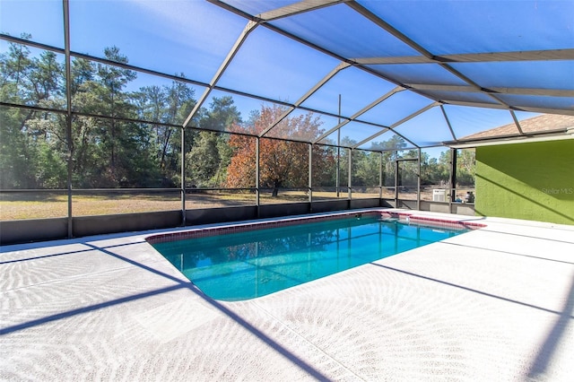 view of swimming pool with a lanai and a patio