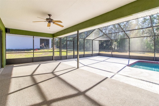 unfurnished sunroom featuring ceiling fan