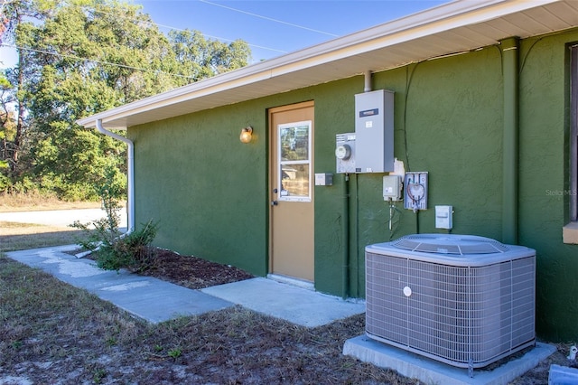 view of exterior entry featuring cooling unit