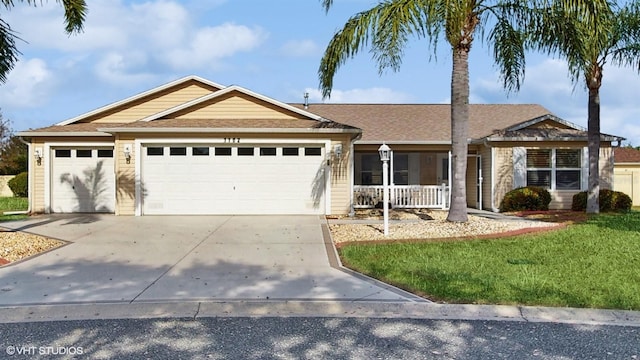 ranch-style house with a garage, driveway, and a front lawn