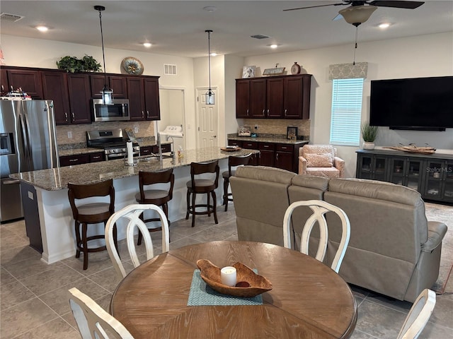 dining room with ceiling fan and light tile patterned flooring