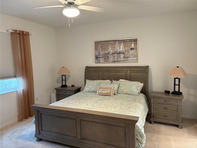 bedroom featuring ceiling fan and light carpet