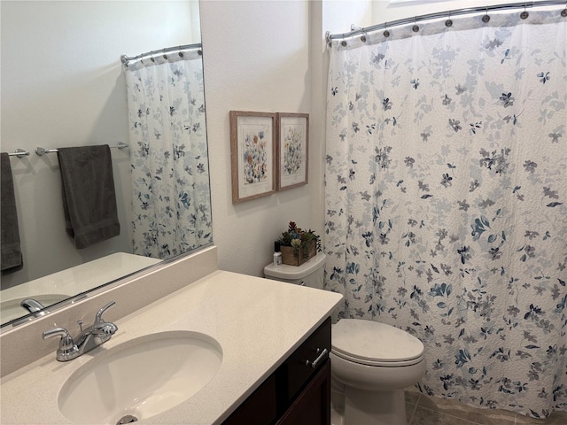 bathroom featuring toilet, tile patterned flooring, vanity, and a shower with shower curtain