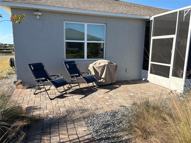 view of patio / terrace with glass enclosure and grilling area