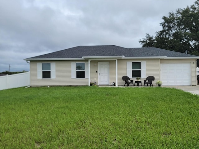 ranch-style house featuring a garage and a front lawn