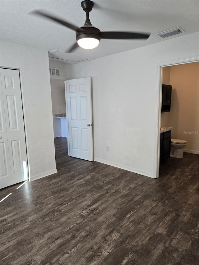 spare room featuring ceiling fan and dark hardwood / wood-style flooring