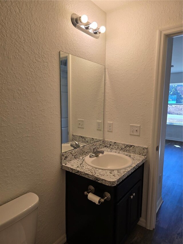 bathroom featuring toilet and vanity