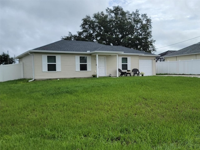 view of front of property with a garage and a front lawn