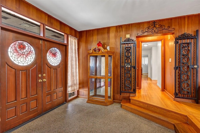 foyer entrance with wood walls