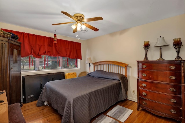 bedroom with light wood-type flooring and ceiling fan