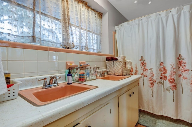 bathroom featuring decorative backsplash and vanity