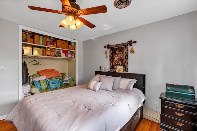 bedroom with ceiling fan, a closet, and light hardwood / wood-style flooring