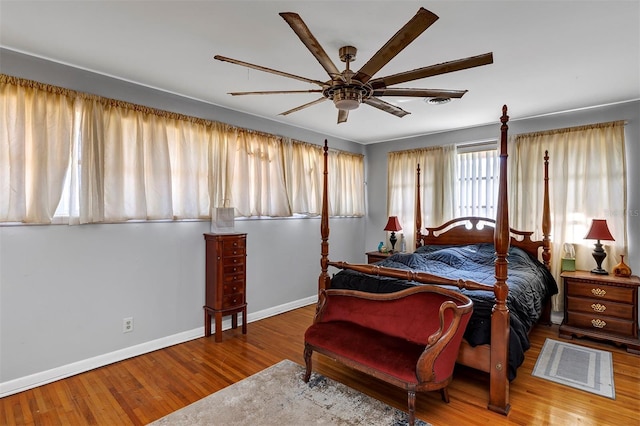 bedroom with wood-type flooring and ceiling fan