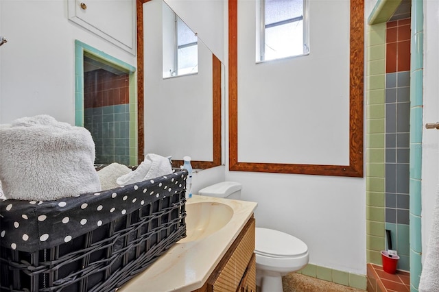 bathroom with tile patterned flooring, vanity, and toilet