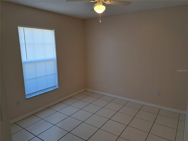 tiled spare room with ceiling fan