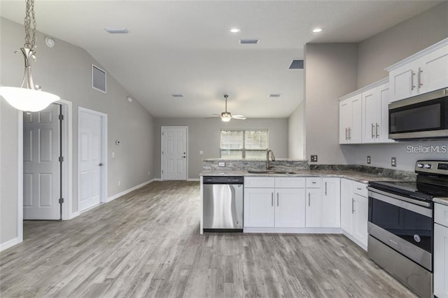 kitchen with white cabinets, sink, ceiling fan, appliances with stainless steel finishes, and light hardwood / wood-style floors